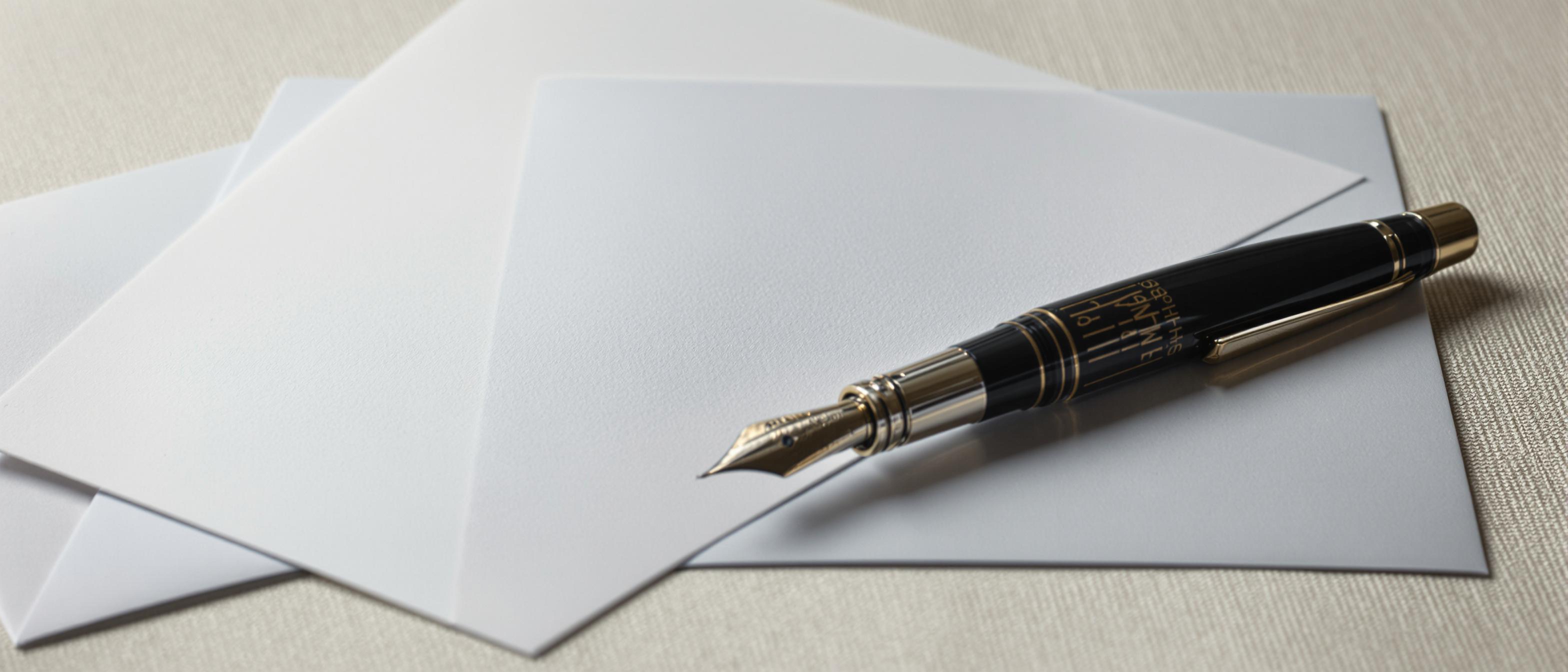 Clean, professional presentation of stationery items on a softly lit surface.